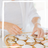 Hands assembling natural seashell compacts filled with solid perfume blends, perfect for eco-conscious aromatherapy lovers.