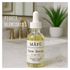 Bottle of Face Serum made with essential oils and all natural sitting next to a bathroom sink